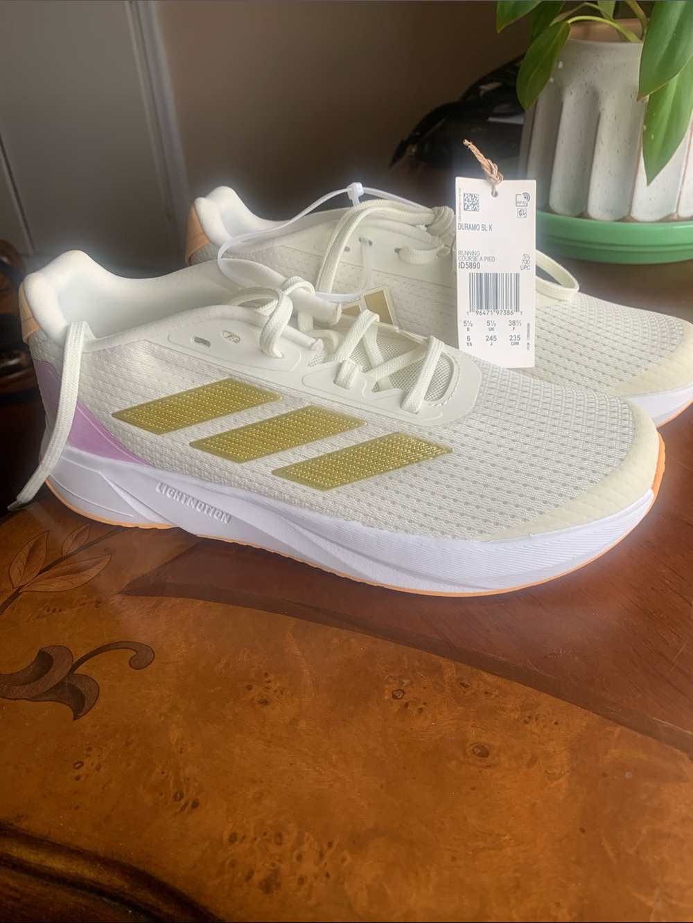 adidas Cream Running Sneakers with Gold Stripes and Pink Heel Accent